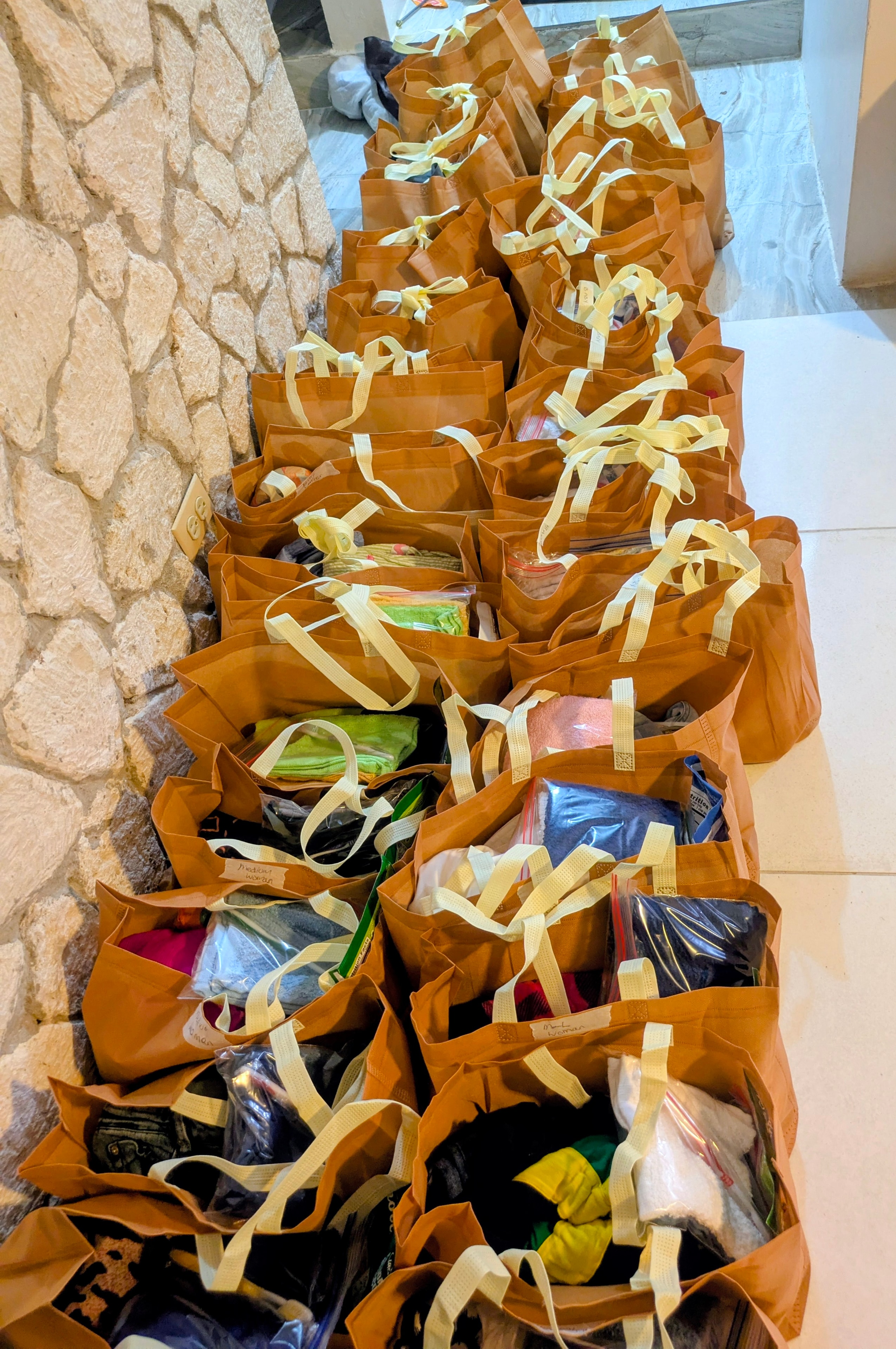 Rows of packed brown relief bags lined up for distribution