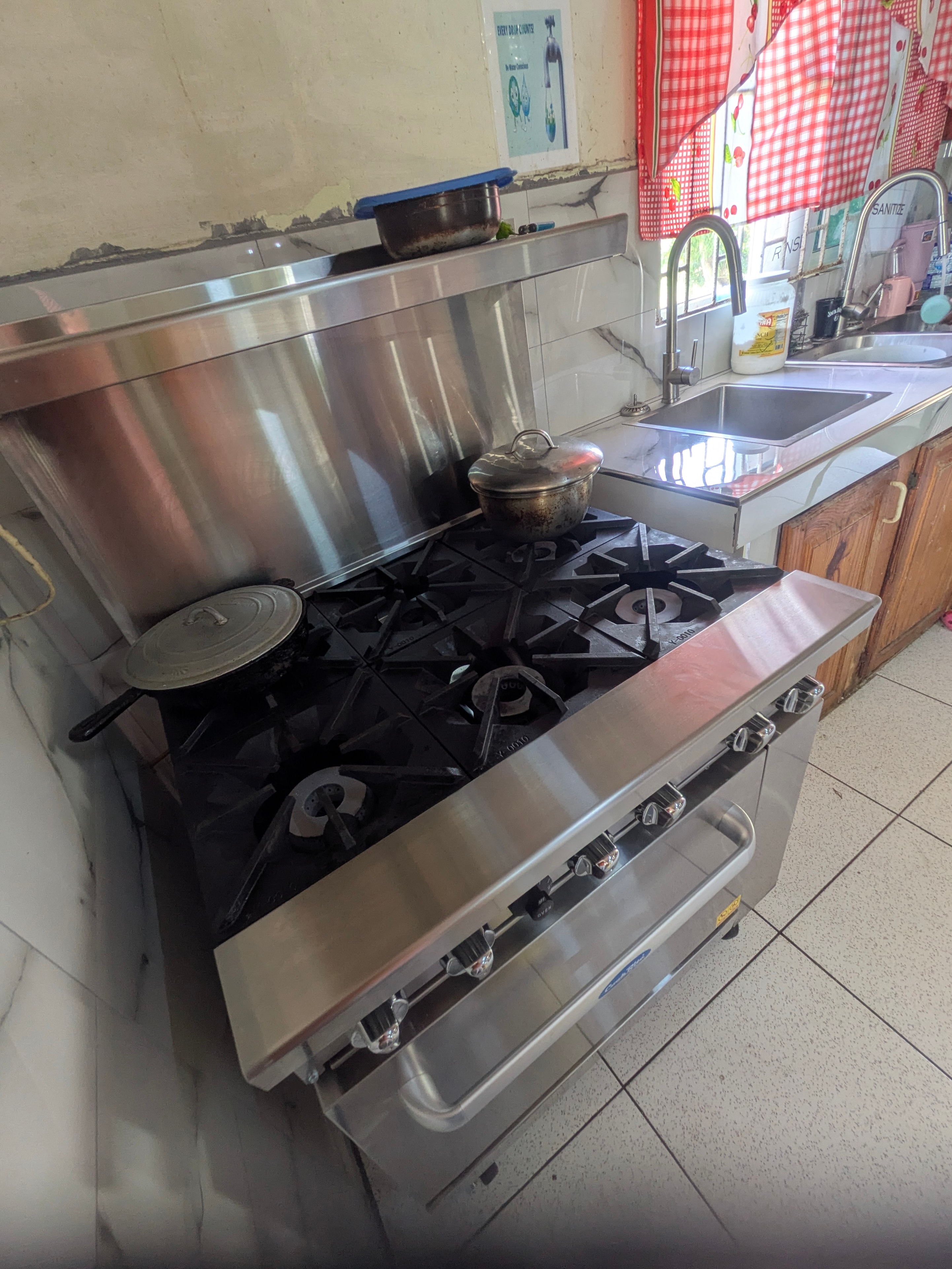 New commercial multi-burner stove at Melody House kitchen